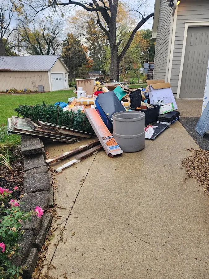 Dumpster being loaded with debris for Estate Cleanout Dumpster Rental in Meridianville